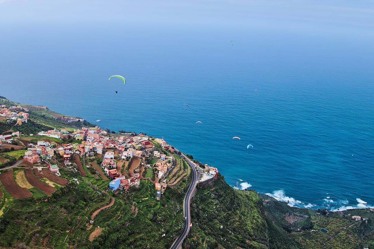 Paragliders flying along the north coast of Tenerife