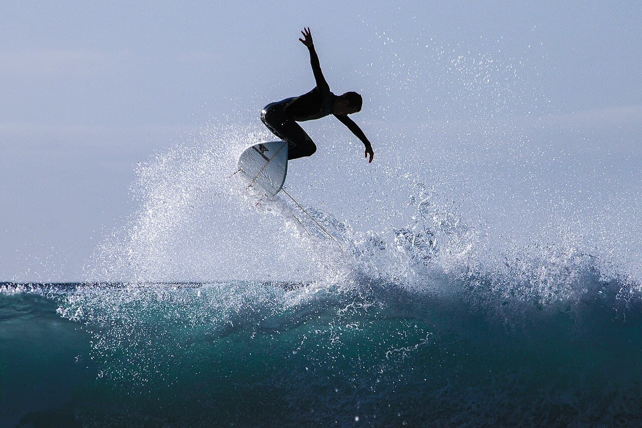 Surfer catching air off a breaking wave in Tenerife
